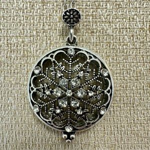 Snowflake silver tone necklace with magnifying glass